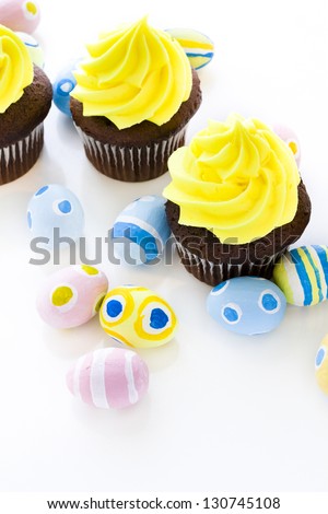Gourmet cupcakes with yellow icing prepared for Easter.