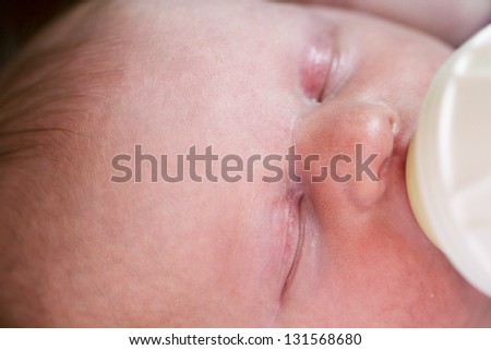 Newborn baby girl at feeding time.