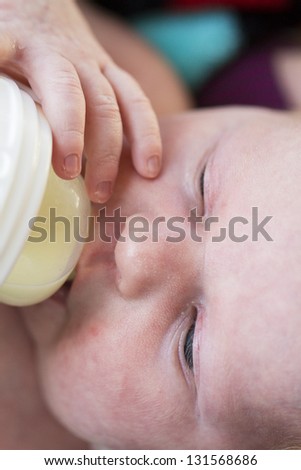 Newborn baby girl at feeding time.