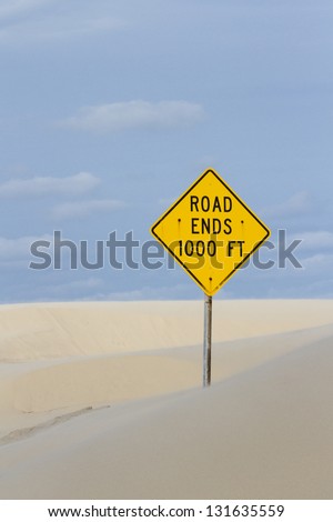 Yellow road sign at the end of the road.