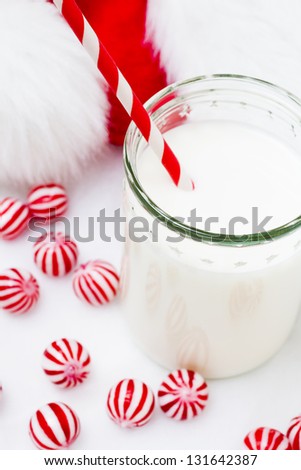 Glass of milk in a jar with a red straw.