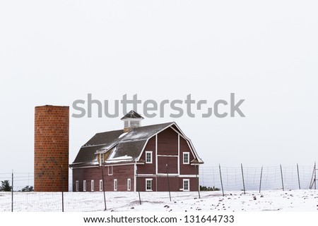 Red barn on western farn in the winter.