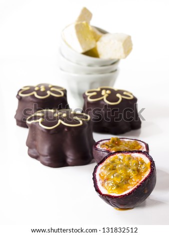 Gourmet chocolate covered passion fruit marshmallows on white background.