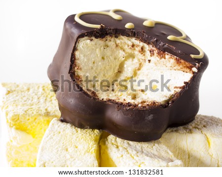 Gourmet chocolate covered passion fruit marshmallows on white background.