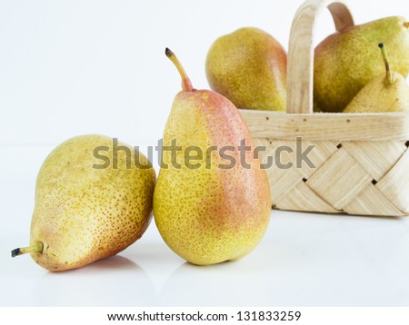 Ripe pear on white background. The cultivation of the pear in cool temperate climates extends to the remotest antiquity, and there is evidence of its use as a food since prehistoric times.