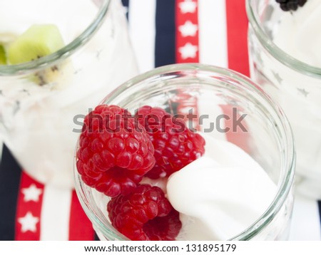 Frozen soft-serve yogurt in cup on bright background.