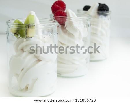Frozen soft-serve yogurt in cup on white background.