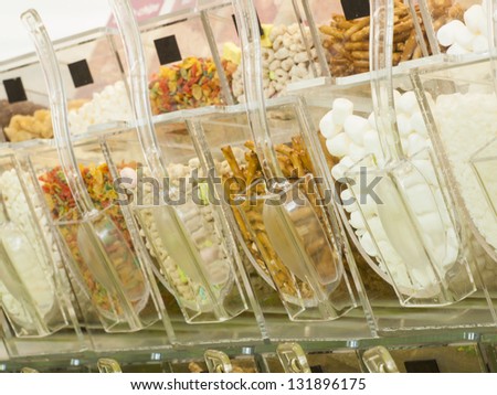 Frozen yogurt toppings bar. Yogurt toppings ranging from fresh fruits, nuts, fresh-cut candies, syrups and sprinkles.