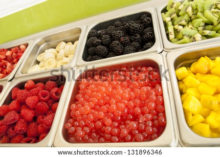 Ã?Â¢??Frozen yogurt toppings bar. Yogurt toppings ranging from fresh fruits, nuts, fresh-cut candies, syrups and sprinkles.
