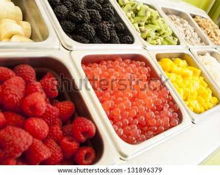 Ã?Â¢??Frozen yogurt toppings bar. Yogurt toppings ranging from fresh fruits, nuts, fresh-cut candies, syrups and sprinkles.