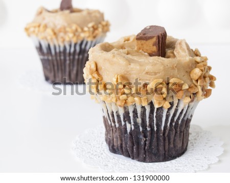 Gourmet Reese\'s peanut butter cups cupcake on white backround.