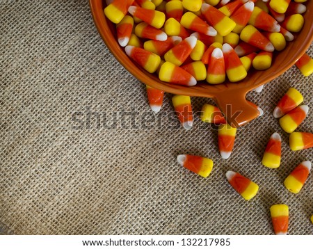 Traditional Halloween candies candy corn in orange bowl.