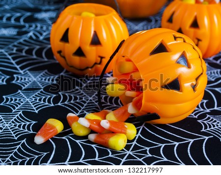 Candy corn candies falling out of Halloween treat bag.