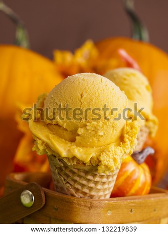 Scoop of gourmet pumpkin gelato in waffle cones.