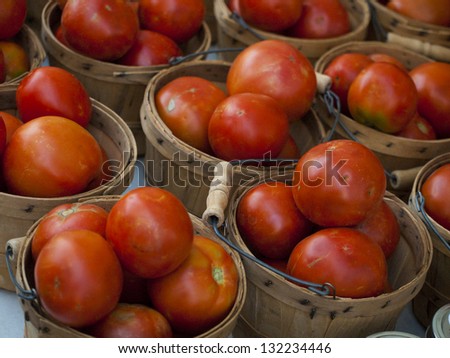 Fresh organic tomatoes at the local farmers market. Farmers markets are a traditional way of selling agricultural products.