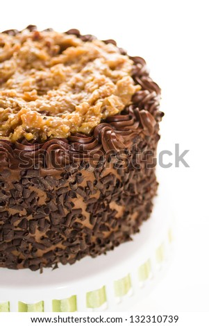 German chocolate cake with two layers of chocolate cake filled and topped with classic German chocolate filling (a caramel-goo of coconut and pecans), covered in chocolate buttercream.