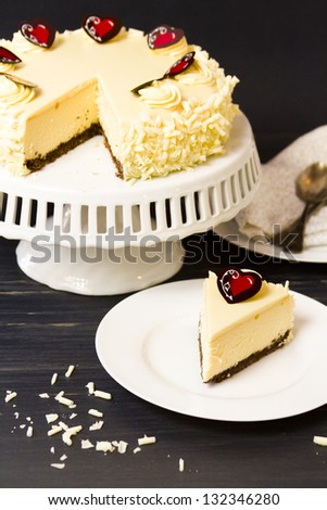 White chocolate cheesecake with brownie crust with white chocolate cream cheese filling, covered in white chocolate ganache.