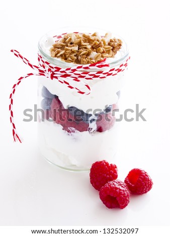 Delicious fruit, greek yogurt and granola parfaits on white background