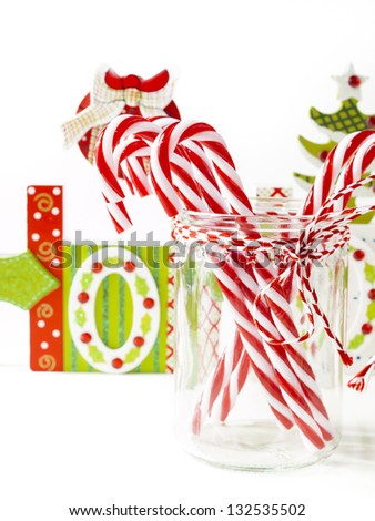 Traditional Christmas Candy Cane in glass on white background.