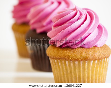 White and pink cupcakes on a white background.