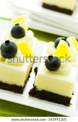 Small white chocolate cheesecake squares at dessert bar.