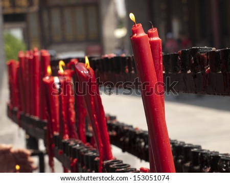 Candle burning at the buddhist temple in Xian, China.