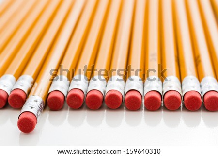 Classic yellow pencils with red eraser on a white background.