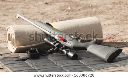 Rifle on the shooting mat with safety on.