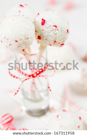 Peppermint chocolate cake pops dipped in white chocolate and candy cane bits.