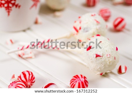 Peppermint chocolate cake pops dipped in white chocolate and candy cane bits.