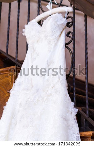 Vintage wedding dress on a hanger.
