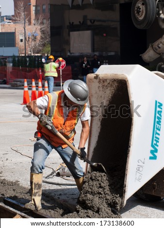 Denver, Colorado-April 9, 2011: Road construction worker on new concrete road in downtown Denver, Colorado.