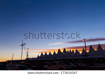 Denver, Colorado-January 19, 2013:Tents of DIA at sunrise. Denver International Airport well known for peaked roof. Design of roof is reflecting snow-capped mountains.