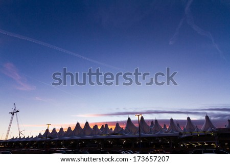Denver, Colorado-January 19, 2013:Tents of DIA at sunrise. Denver International Airport well known for peaked roof. Design of roof is reflecting snow-capped mountains.