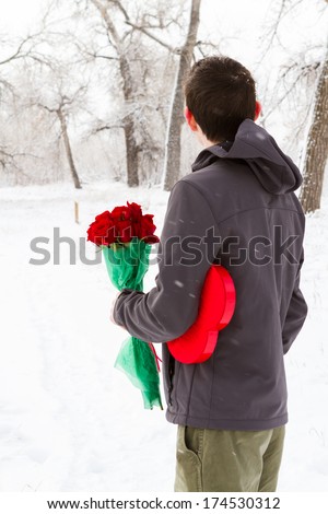 Teenager boy with Valentines Day gifts waiting for his girlfriend.