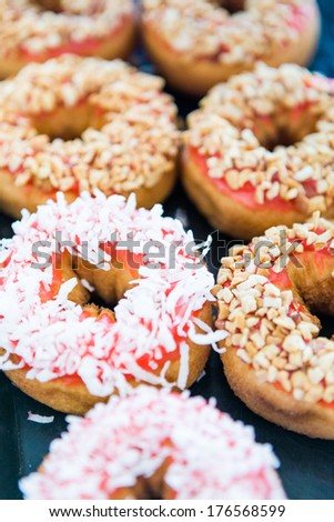 Variery of fresh donuts with different toppings from the local bakery shop.
