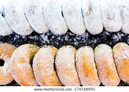Row of fresh donuts from the local bakery shop.