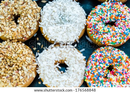 Fresh donuts with different toppings from the local bakery shop.