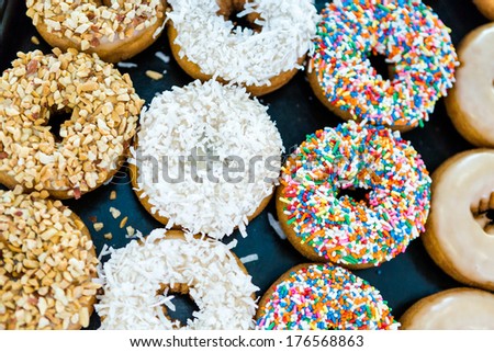 Fresh donuts with different toppings from the local bakery shop.