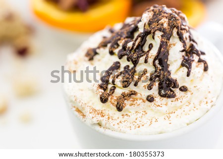 Cappuccino with delicate dollop of whipped cream.