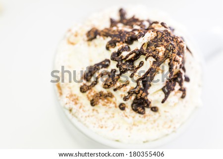 Cappuccino with delicate dollop of whipped cream.