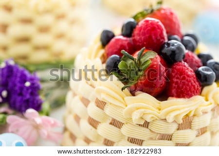 Easter basket mini cakes with glazed fresh fruit on top.