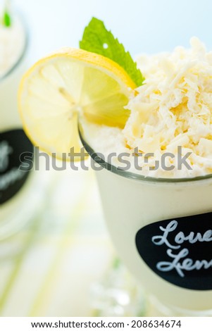 Gourmet cold lovely lemon chocolate drink garnished with white chocolate, lemon and mint.