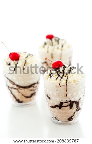 Gourmet cold Banana split chocolate drink garnished with dark chocolate and cherry.