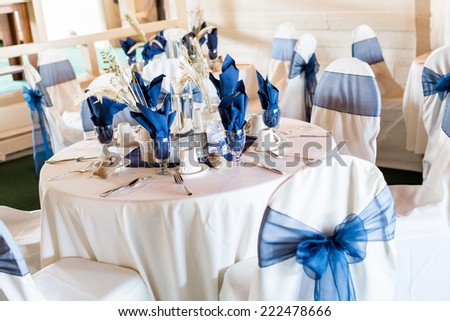 Banquet hall decorated for wedding in white and blue.