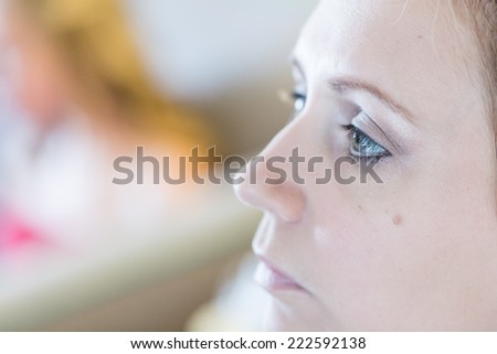 Makeup artist applying make up to the brides face.