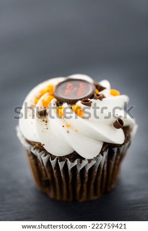 Chocolate Halloween cupcakes with white buttercreme icing and chocolate shavings on top.