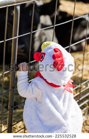 Cute kids in Halloween costumes at the petting zoo.