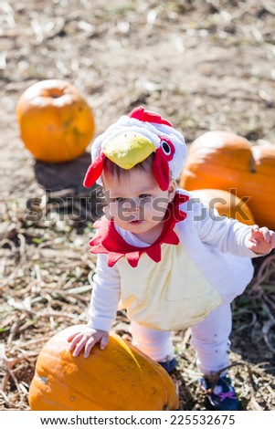 Cute kids in Halloween costumes at the pumpkin patch.