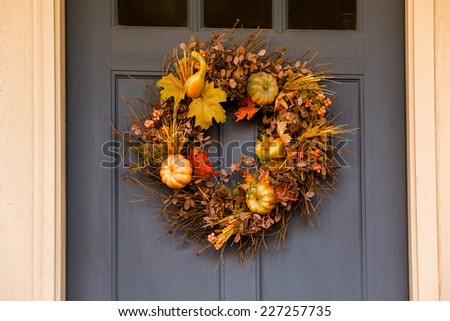 Autumn wreath decorating front door.